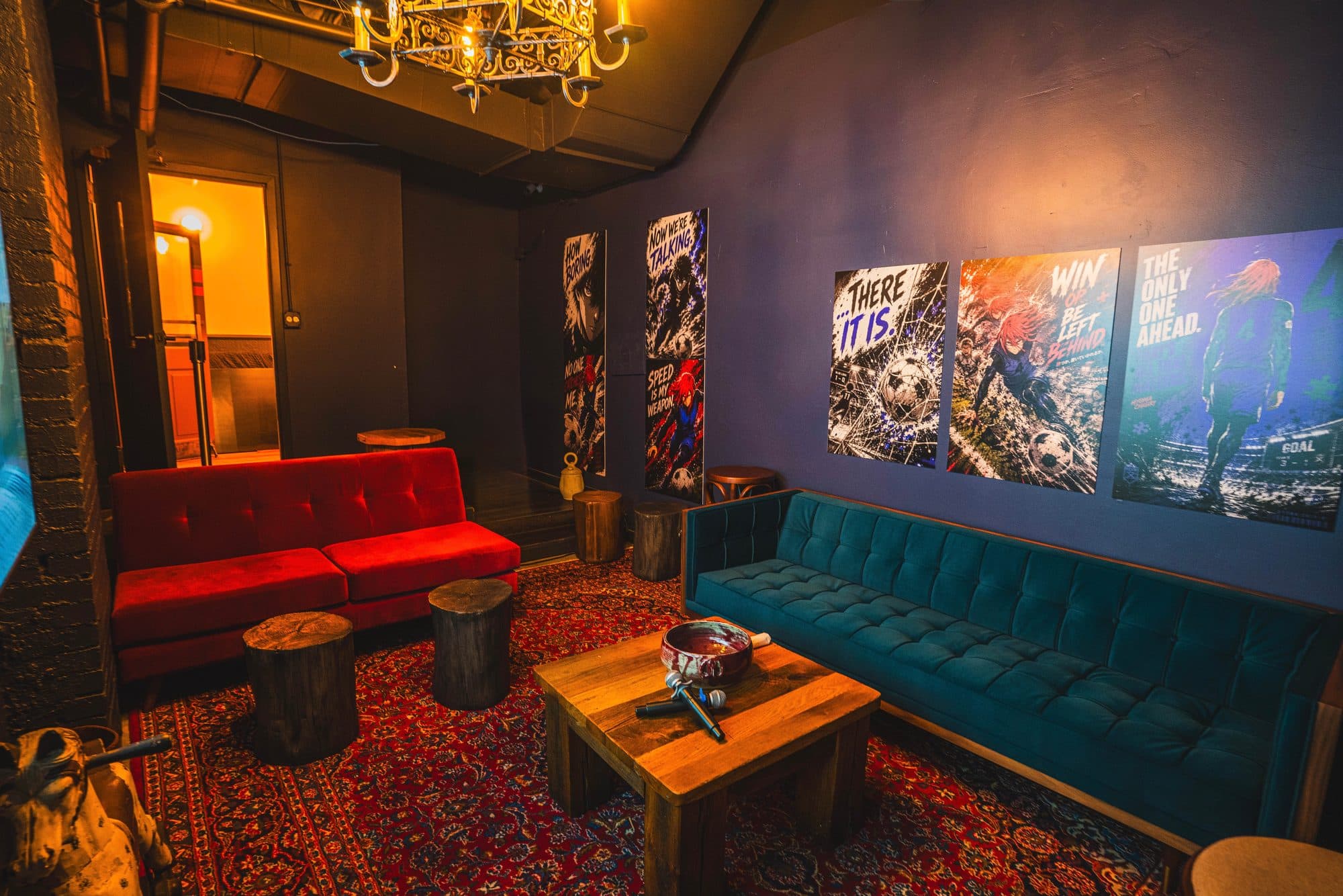 Velvet sofas, two wireless mics and a chandelier in a karaoke room at BARna