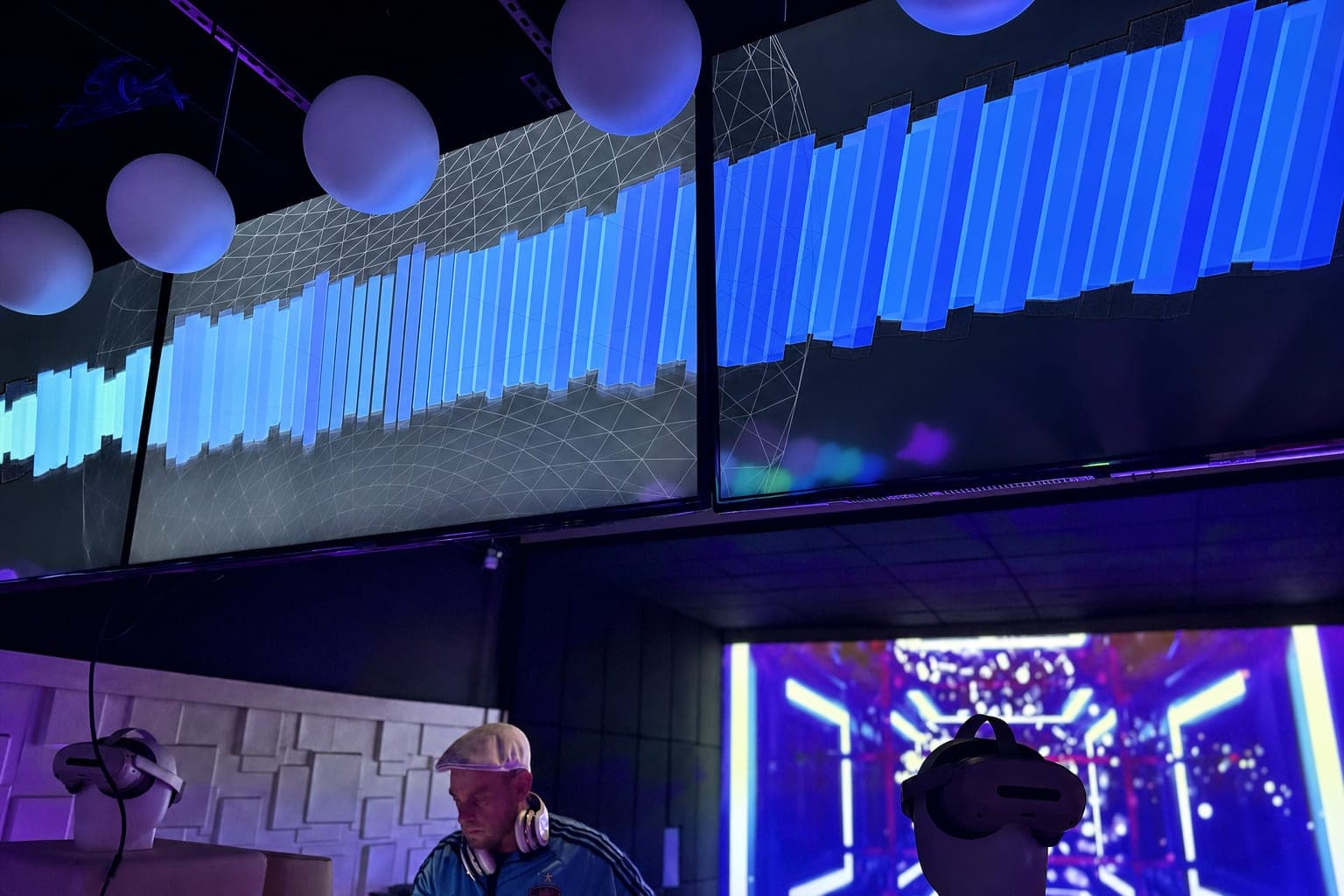 Waveform video wall above the DJ booth with LED chevrons
