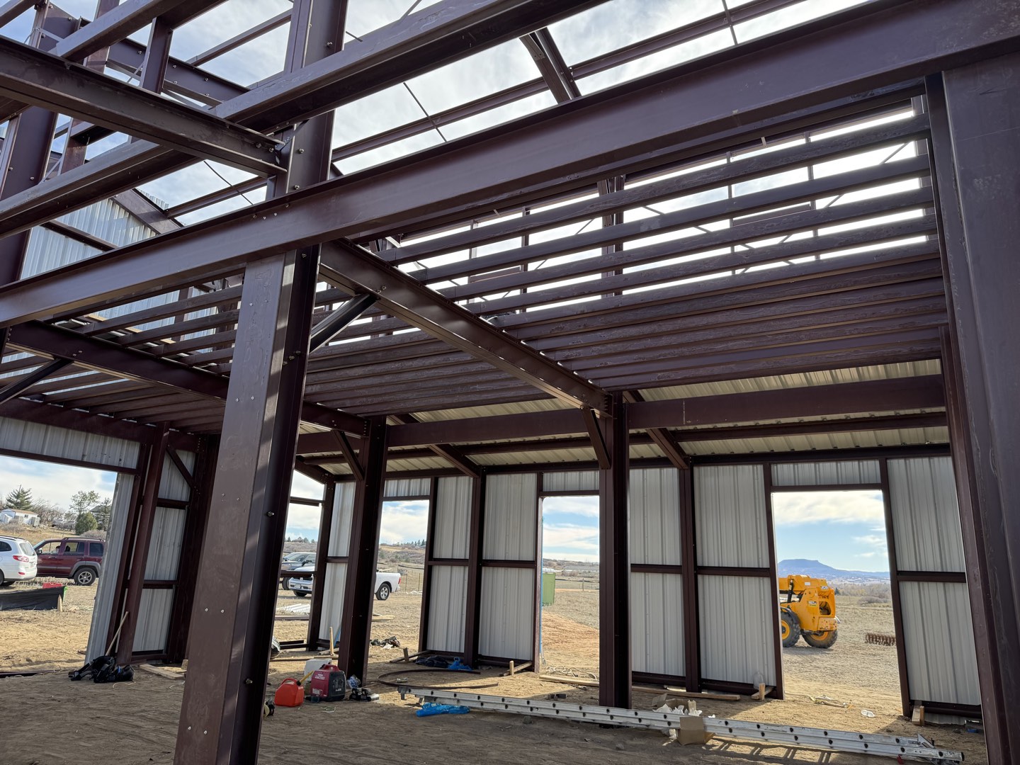 Red-iron steel frame and roof purlins going up on open prairie in Sedalia