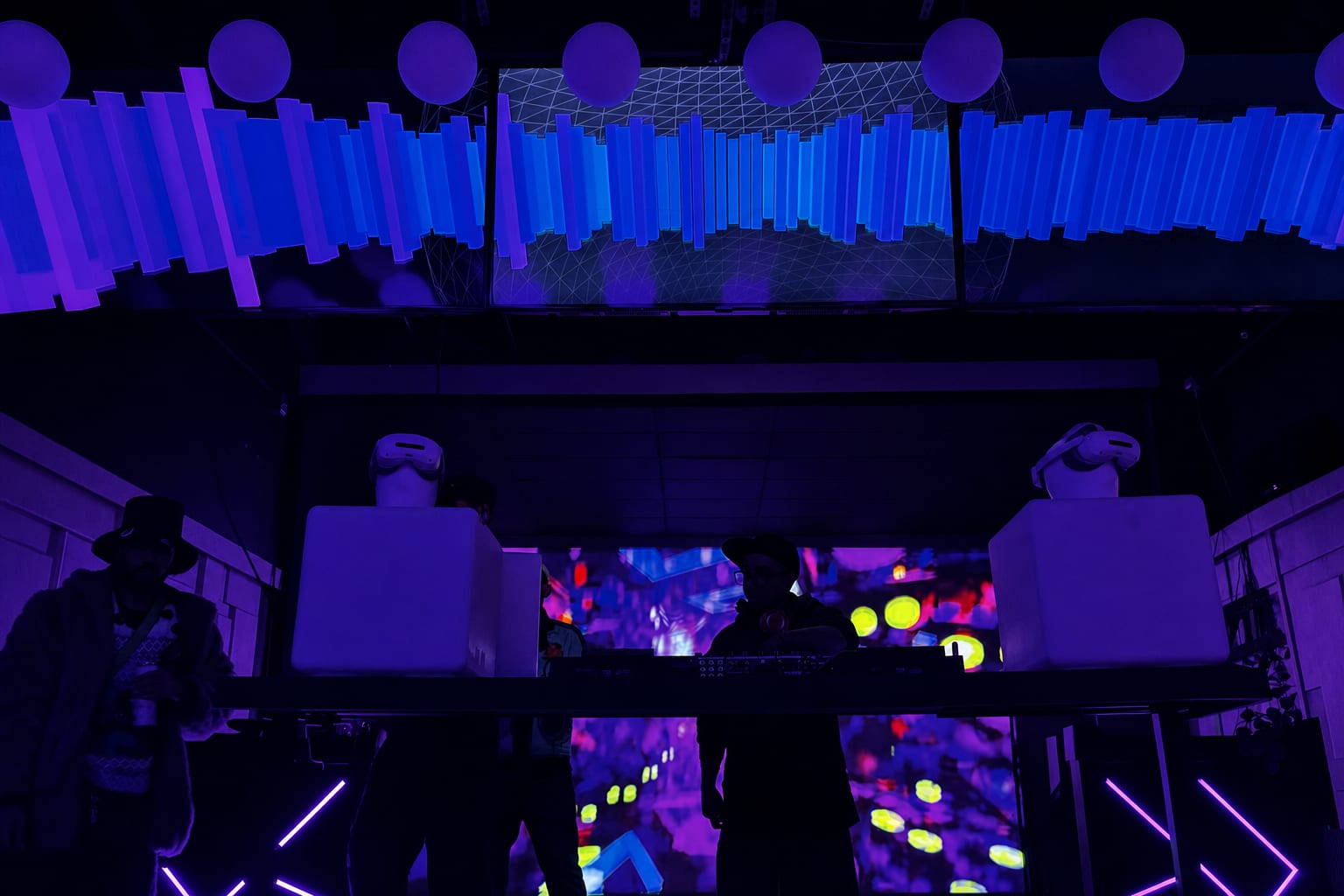 Projection-mapped walls washing the room in visuals