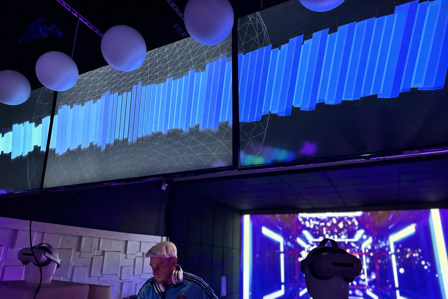 Waveform video wall above the DJ booth with LED chevrons